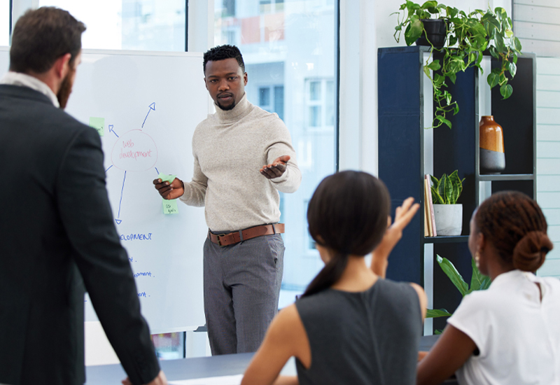 Instructor teaching a process safety training course to participants in a classroom.